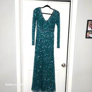 Dark green Aidan Mattox, sequin, long sleeve formal dress with beaded Detailing.